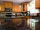 Gourmet kitchen featuring dark granite countertops, tile backsplash, and stainless steel appliances at 132 Hammond Dr, Canton, GA 30114