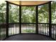 A cozy screened-in porch overlooks a lush backyard with mature trees and a wooden fence at 132 Hammond Dr, Canton, GA 30114