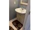 Bathroom featuring a single sink vanity with a modern faucet, set against neutral tile and gray walls at 1470 Andrews Nw St, Atlanta, GA 30314