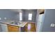 Well-lit kitchen showcasing a dishwasher, refrigerator, and a dining area in a home with hardwood flooring at 1470 Andrews Nw St, Atlanta, GA 30314