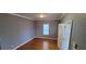 A naturally lit living room with hardwood floors, grey walls, and a window facing the backyard at 1470 Andrews Nw St, Atlanta, GA 30314