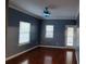 Living room with new ceiling fan, freshly painted walls, and a door leading to an outdoor deck at 1470 Andrews Nw St, Atlanta, GA 30314