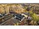 Bird's-eye view of a home with manicured backyard, showcasing its location surrounded by mature trees and nearby roadways at 1798 Braselton Hwy, Lawrenceville, GA 30043