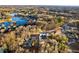 Expansive aerial view of a luxurious home on a large lot, surrounded by lush trees and a serene lake at 1798 Braselton Hwy, Lawrenceville, GA 30043