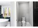Contemporary bathroom with toilet, and luxurious soaking tub next to window at 1798 Braselton Hwy, Lawrenceville, GA 30043