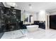 Modern bathroom features marble floors, shower, black accent wall, and soaking tub at 1798 Braselton Hwy, Lawrenceville, GA 30043