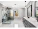 Modern bathroom featuring a glass enclosed shower and double vanity with gray cabinets and white countertop at 1798 Braselton Hwy, Lawrenceville, GA 30043