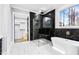 Luxurious bathroom featuring a soaking tub, glass shower, and walk-in closet access at 1798 Braselton Hwy, Lawrenceville, GA 30043