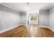 Bright bedroom with hardwood floors, a chandelier, and neutral walls offers a spacious, airy feel at 1798 Braselton Hwy, Lawrenceville, GA 30043