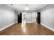 Open bedroom featuring hardwood floors, gray walls, white trim, and black doors to adjoining rooms at 1798 Braselton Hwy, Lawrenceville, GA 30043