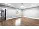 Bright bedroom with hardwood floors, modern lighting, and large windows at 1798 Braselton Hwy, Lawrenceville, GA 30043