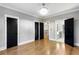 Spacious bedroom boasting hardwood floors and multiple black doors at 1798 Braselton Hwy, Lawrenceville, GA 30043