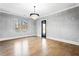 Formal dining room featuring hardwood floors, modern chandelier, and lots of natural light at 1798 Braselton Hwy, Lawrenceville, GA 30043