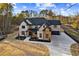 Stunning two-story home featuring a combination of brick and stone, a dark roof, and a long driveway at 1798 Braselton Hwy, Lawrenceville, GA 30043