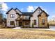 Beautiful two-story brick home featuring stone accents, a covered porch, and a well-manicured front yard at 1798 Braselton Hwy, Lawrenceville, GA 30043