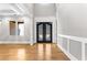 Elegant foyer with hardwood floors, decorative molding, and a stylish double door entrance at 1798 Braselton Hwy, Lawrenceville, GA 30043
