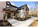 Stately home with stone and brick facade, featuring an elegant entryway and meticulous landscaping at 1798 Braselton Hwy, Lawrenceville, GA 30043