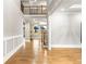 Inviting hallway with beautiful hardwood floors, wood trim and a view of the living room at 1798 Braselton Hwy, Lawrenceville, GA 30043