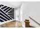 Hallway featuring modern geometric wall design, hardwood flooring, and neutral paint at 1798 Braselton Hwy, Lawrenceville, GA 30043