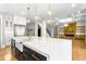 Spacious kitchen island with a farmhouse sink and gold faucet, and an open view to the living room at 1798 Braselton Hwy, Lawrenceville, GA 30043