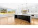 Spacious kitchen with white cabinets, a large center island, and abundant natural light from the large windows at 1798 Braselton Hwy, Lawrenceville, GA 30043