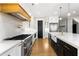 Open-concept kitchen with stainless steel appliances, a large island with a farmhouse sink, and gold accents at 1798 Braselton Hwy, Lawrenceville, GA 30043