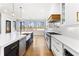 Bright kitchen features white cabinets, black island with gold hardware, and stainless steel appliances at 1798 Braselton Hwy, Lawrenceville, GA 30043