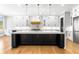 Bright kitchen features white cabinets, black island with gold hardware, and stainless steel appliances at 1798 Braselton Hwy, Lawrenceville, GA 30043