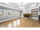 Cozy living room featuring hardwood floors, fireplace, and multiple windows at 1798 Braselton Hwy, Lawrenceville, GA 30043