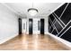 Open living room featuring hardwood floors, decorative wall and modern chandelier at 1798 Braselton Hwy, Lawrenceville, GA 30043