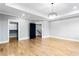 Spacious bedroom with hardwood floors, large windows, recessed lighting, and tray ceiling with modern chandelier at 1798 Braselton Hwy, Lawrenceville, GA 30043