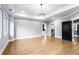 Spacious bedroom with hardwood floors, large windows, recessed lighting, and tray ceiling with modern chandelier at 1798 Braselton Hwy, Lawrenceville, GA 30043