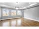 Spacious bedroom with hardwood floors, large windows, recessed lighting, and tray ceiling with modern chandelier at 1798 Braselton Hwy, Lawrenceville, GA 30043