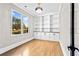 Bright office space with hardwood floors, custom built-in bookshelves, and a large window for natural light at 1798 Braselton Hwy, Lawrenceville, GA 30043
