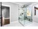 Modern marble shower with glass enclosure, black hardware, and natural light from an adjacent window at 1798 Braselton Hwy, Lawrenceville, GA 30043