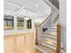 Staircase featuring hardwood steps, modern railing, and an open view of the living room and outside at 1798 Braselton Hwy, Lawrenceville, GA 30043
