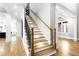 Elegant staircase with hardwood steps, iron railing, and detailed trim work at 1798 Braselton Hwy, Lawrenceville, GA 30043
