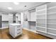 Spacious walk-in closet with custom shelving, drawers, and hardwood floors at 1798 Braselton Hwy, Lawrenceville, GA 30043