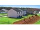 Landscaped backyard featuring a gentle slope, fresh mulch, and lush green grass at 8590 Secretariat Dr, Lithonia, GA 30058