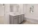 Bright bathroom with a large mirror, double sinks, and bathtub at 8590 Secretariat Dr, Lithonia, GA 30058