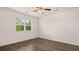 Well-lit bedroom featuring hardwood flooring and a window with a view of the outdoors at 8590 Secretariat Dr, Lithonia, GA 30058