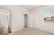 Bright bedroom with carpet floors, a large window, and closet at 8590 Secretariat Dr, Lithonia, GA 30058