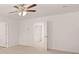 A bright bedroom features neutral carpet, ceiling fan, and an doorway at 8590 Secretariat Dr, Lithonia, GA 30058