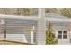 A white house with a grey roof is framed by a window at 8590 Secretariat Dr, Lithonia, GA 30058