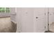 Hallway showcasing interior door, utility closet and hardwood floors at 8590 Secretariat Dr, Lithonia, GA 30058
