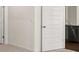 Clean hallway featuring modern doors and an attractive view of the kitchen area at 8590 Secretariat Dr, Lithonia, GA 30058