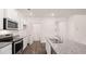 Modern kitchen featuring stainless steel appliances, white cabinets, and granite countertops at 8590 Secretariat Dr, Lithonia, GA 30058