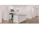 Well-equipped kitchen with white cabinets, stainless steel appliances, a granite island, and hardwood floors at 8590 Secretariat Dr, Lithonia, GA 30058