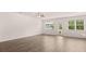 Open living room filled with natural light from windows and door at 8590 Secretariat Dr, Lithonia, GA 30058