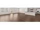 Bright open-concept living area with hardwood floors, a kitchen with stainless steel appliances, and natural light at 8590 Secretariat Dr, Lithonia, GA 30058